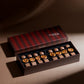 Chocolate assortment in a striped box on a brown background